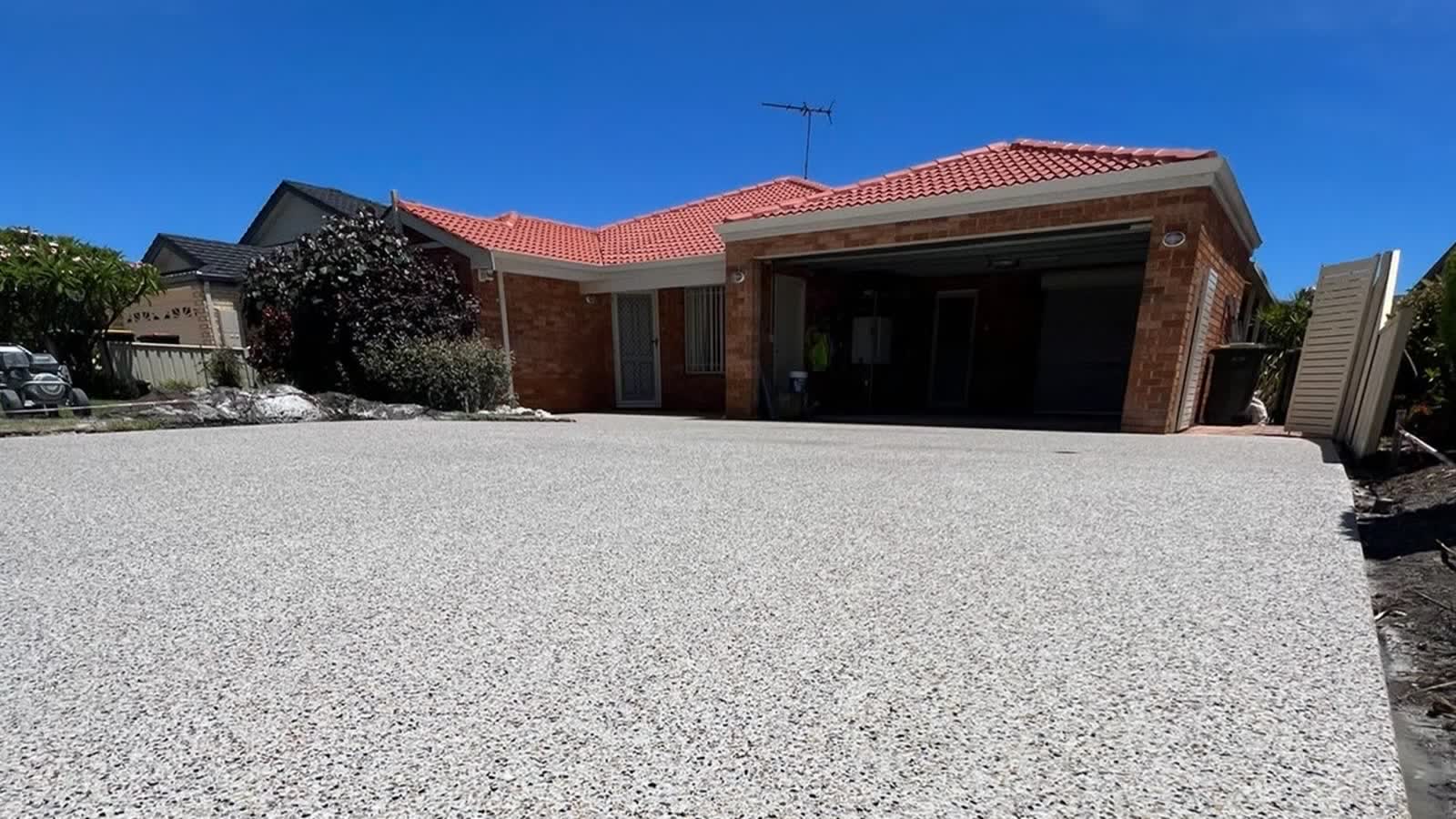 Freshly laid exposed aggregate concrete driveway